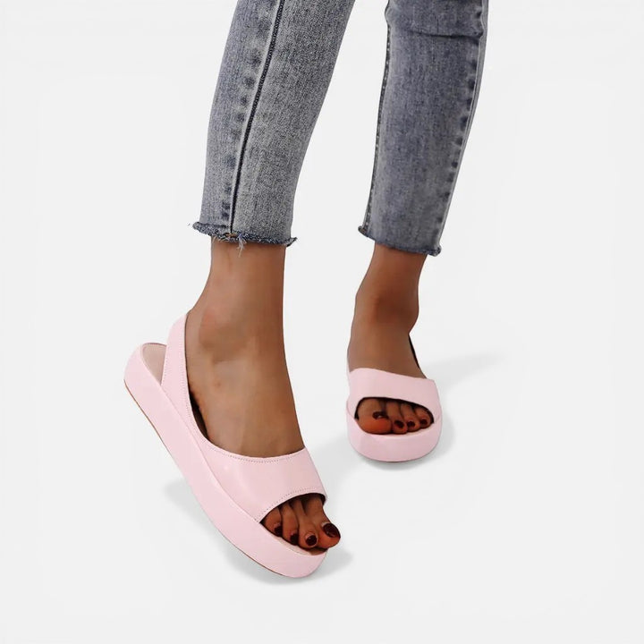 Laurior | Sandales ouvertes en cuir pour femmes avec bride arrière portées avec un jean, couleur rose.